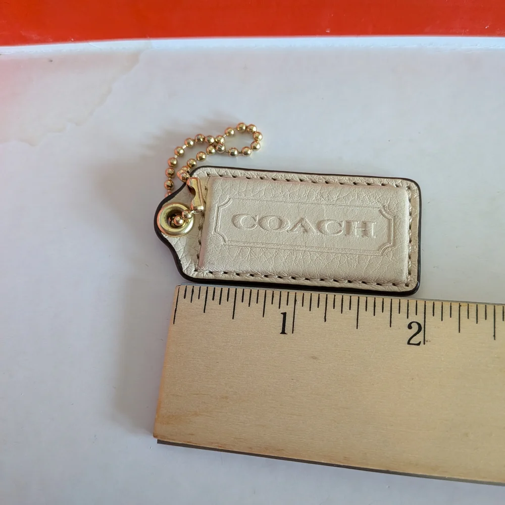 Coach White Pebbled‎ Leather Hang Tag in Cream with Gold Chain